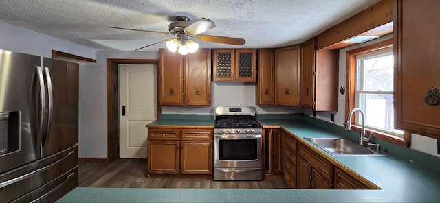 kitchen with dark hardwood / wood-style flooring, sink, stainless steel appliances, and a textured ceiling