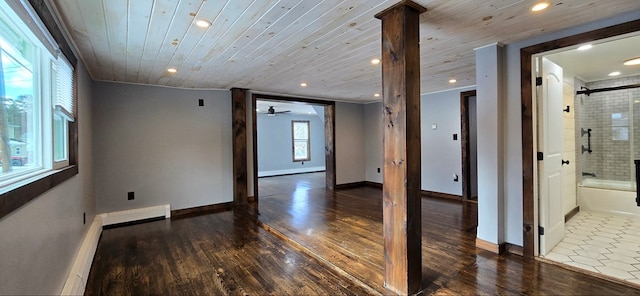 empty room with wooden ceiling, dark hardwood / wood-style floors, and decorative columns