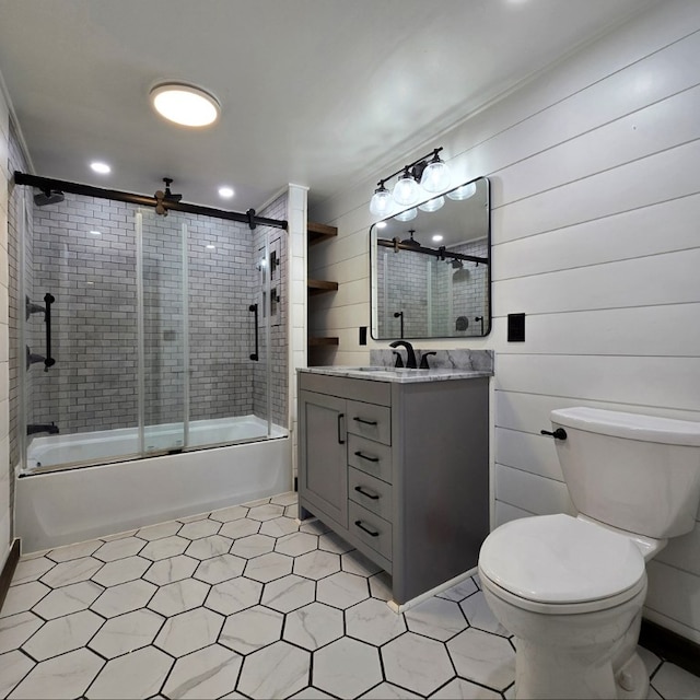 full bathroom with toilet, vanity, and shower / bath combination with glass door