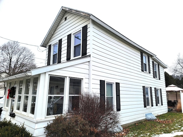 view of side of home with a sunroom