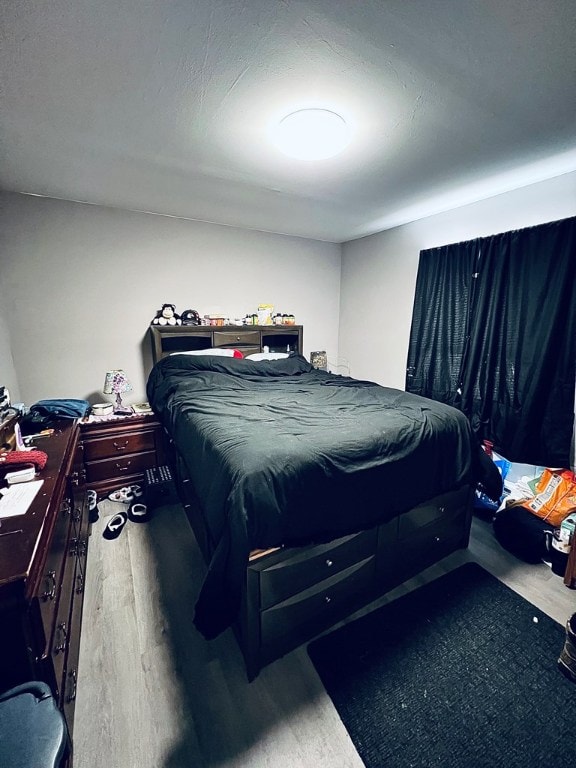 bedroom with wood finished floors