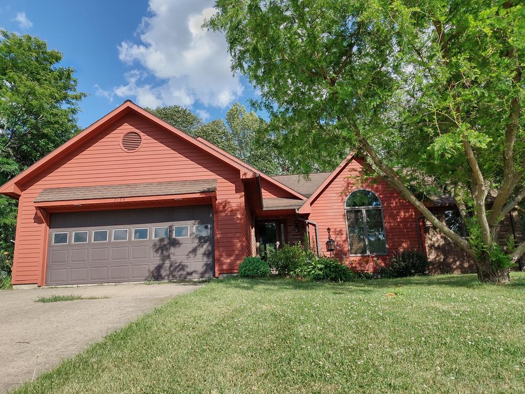 view of front of house with a garage and a front yard
