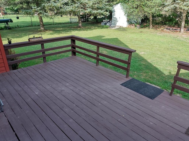 wooden deck with a lawn