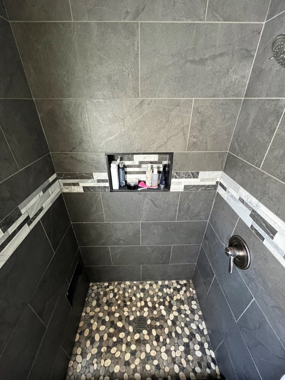 bathroom with a tile shower