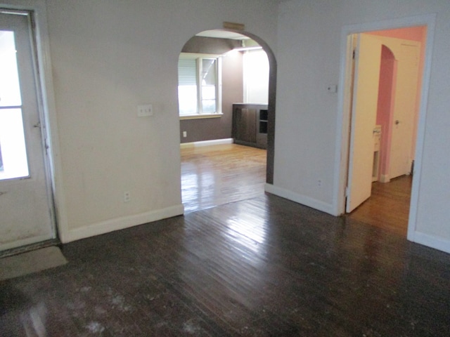 unfurnished room featuring dark wood-type flooring