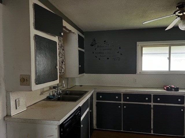 kitchen featuring ceiling fan, black dishwasher, sink, and a textured ceiling