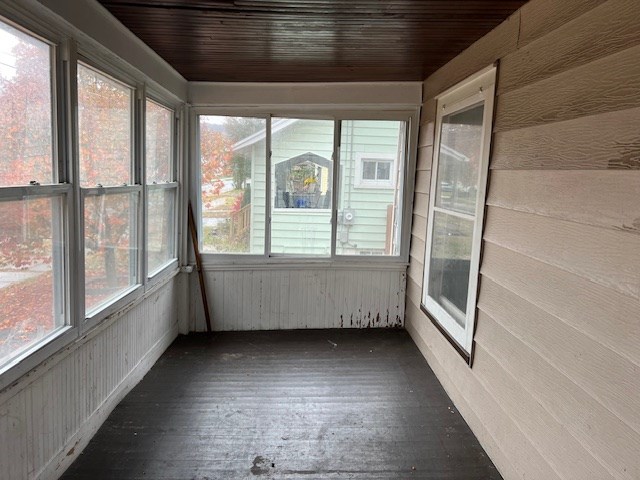 unfurnished sunroom with wood ceiling