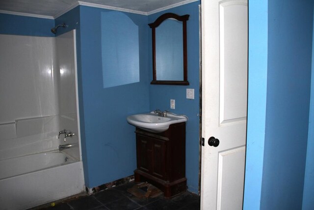 bathroom with ornamental molding, bathing tub / shower combination, and vanity