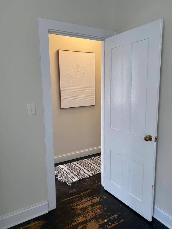 hallway with dark hardwood / wood-style floors