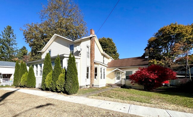 view of side of home with a yard