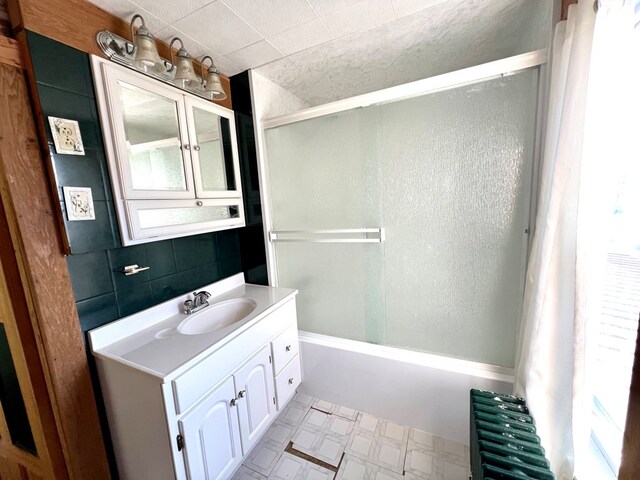 bathroom with vanity, radiator heating unit, and tub / shower combination