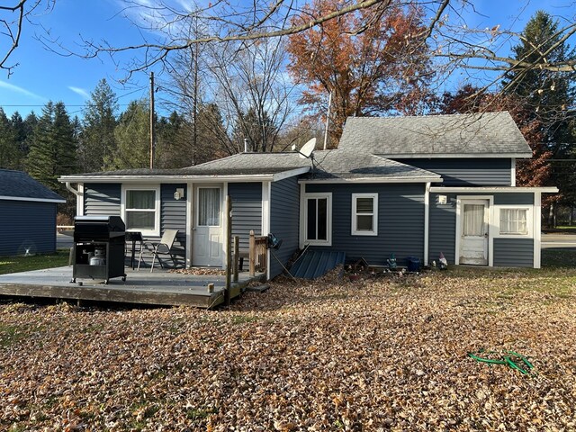 back of house with a deck