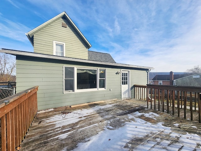 rear view of property featuring a deck