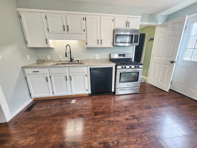 kitchen featuring light stone countertops, white cabinetry, appliances with stainless steel finishes, and sink