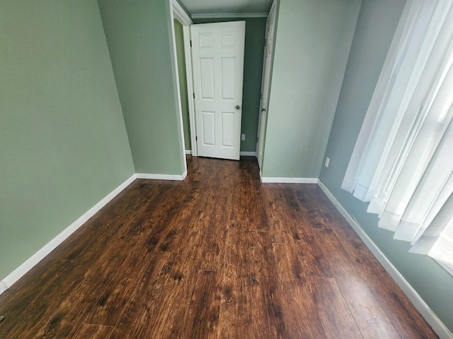 empty room with dark hardwood / wood-style flooring