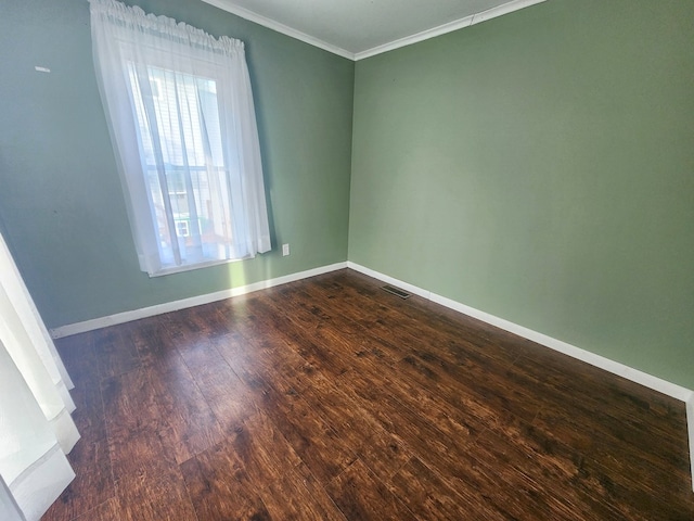 unfurnished room featuring ornamental molding and dark hardwood / wood-style floors