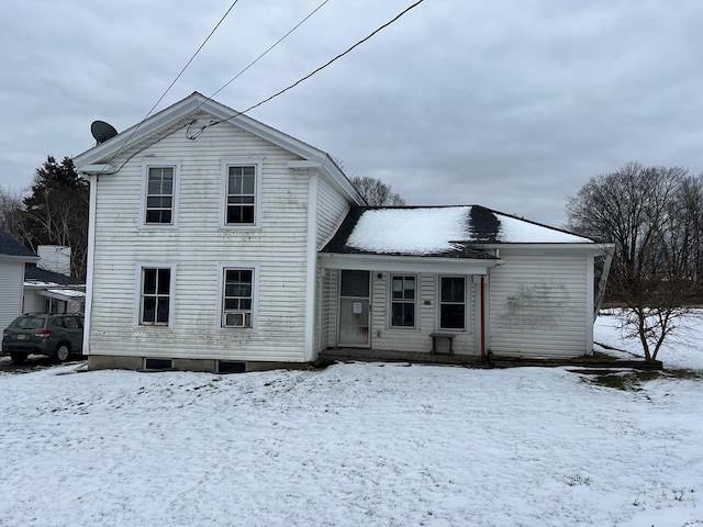 view of snow covered rear of property