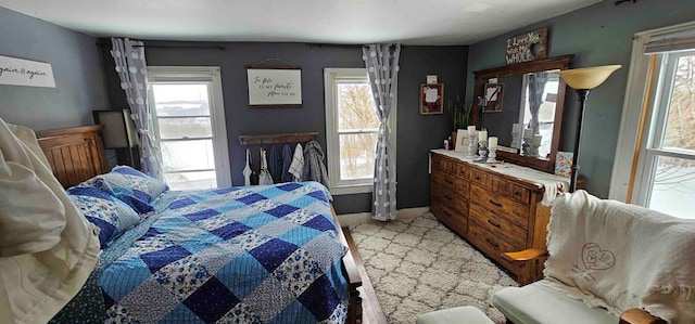 carpeted bedroom featuring multiple windows