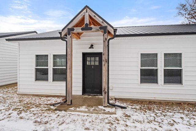 view of snow covered property entrance