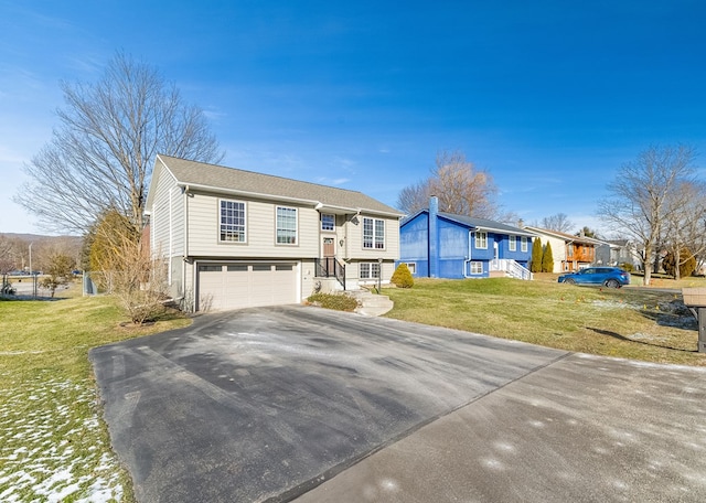 raised ranch with a garage and a front lawn