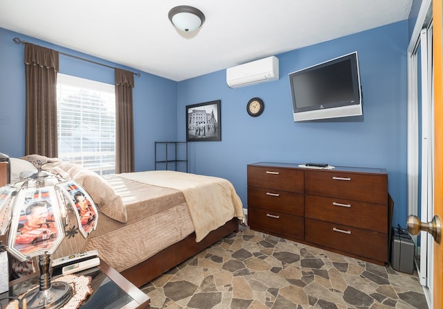 bedroom with a closet and an AC wall unit