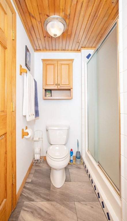 bathroom with toilet, wood ceiling, and a shower with shower door