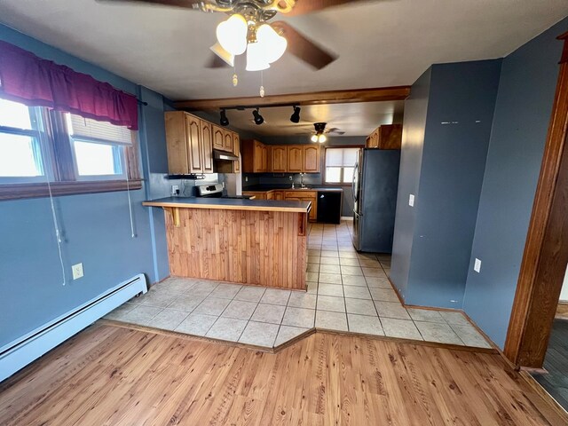 kitchen with stainless steel refrigerator, a baseboard heating unit, ceiling fan, kitchen peninsula, and light wood-type flooring