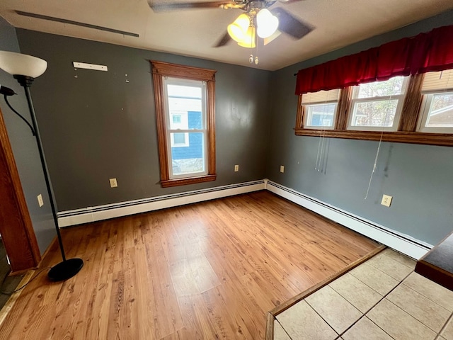 unfurnished room with baseboard heating, ceiling fan, and hardwood / wood-style flooring