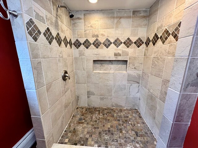 bathroom featuring a tile shower