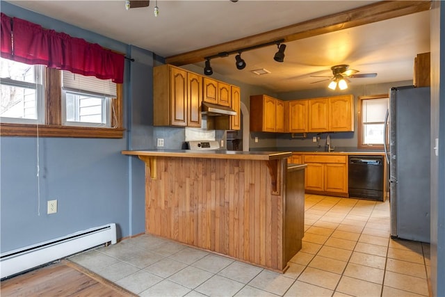 kitchen with dishwasher, freestanding refrigerator, a peninsula, baseboard heating, and under cabinet range hood