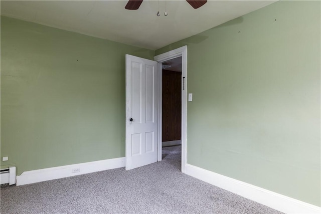 carpeted spare room with ceiling fan, baseboards, and baseboard heating