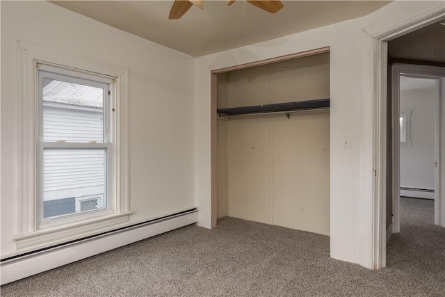 unfurnished bedroom with a baseboard heating unit, carpet, a closet, and ceiling fan