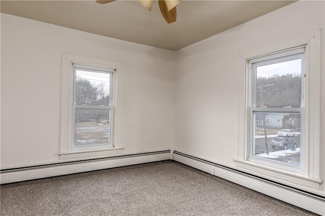 spare room featuring carpet, a baseboard radiator, and a ceiling fan