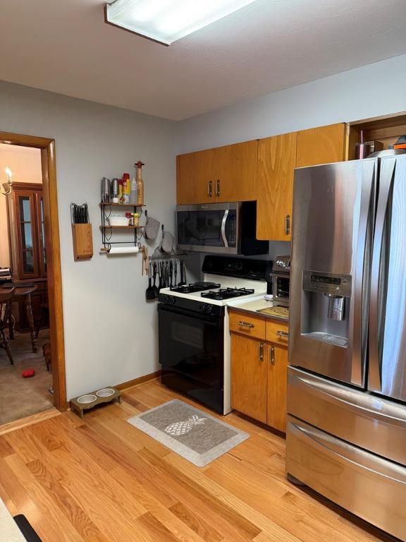 175 Beartown Rd, Erwin, NY 14870 - kitchen featuring stainless steel appliances, light wood-style flooring, brown cabinetry, and light countertops