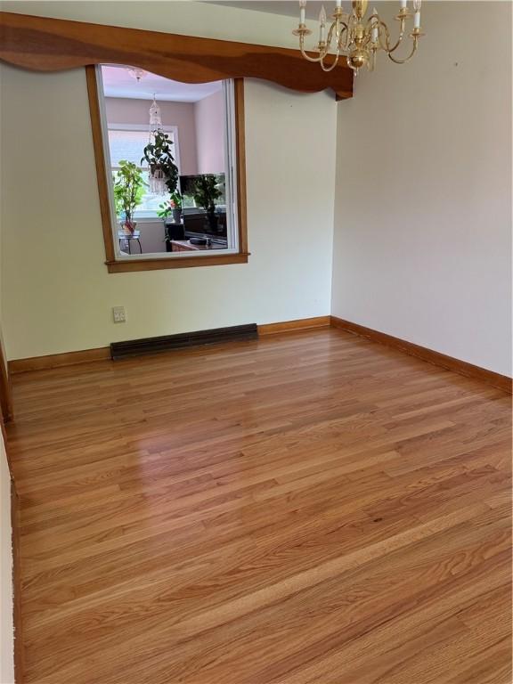 175 Beartown Rd, Erwin, NY 14870 - unfurnished room featuring a chandelier, wood finished floors, and baseboards