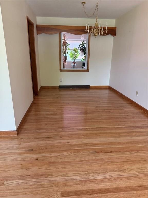 175 Beartown Rd, Erwin, NY 14870 - unfurnished room with a chandelier, light wood-style floors, and baseboards