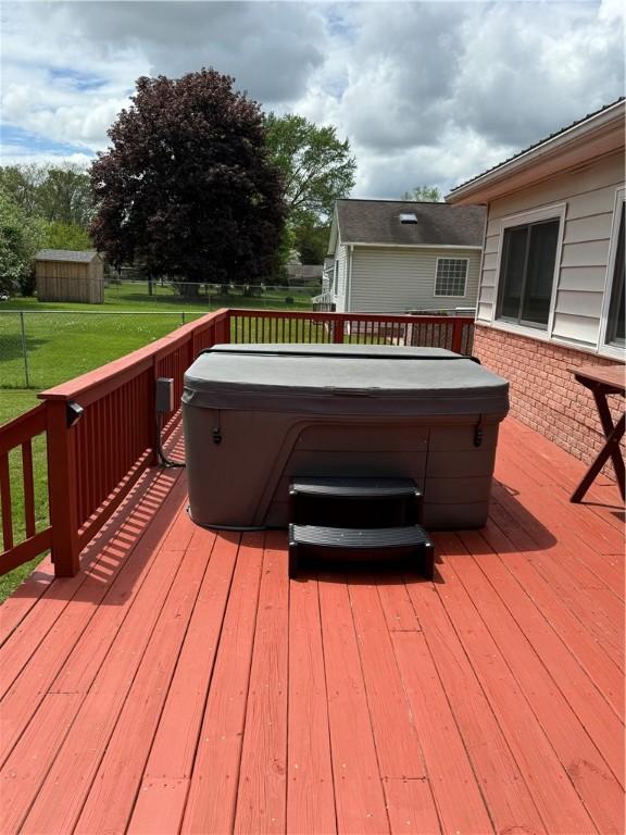 175 Beartown Rd, Erwin, NY 14870 - wooden deck with a hot tub, an outbuilding, and a storage shed