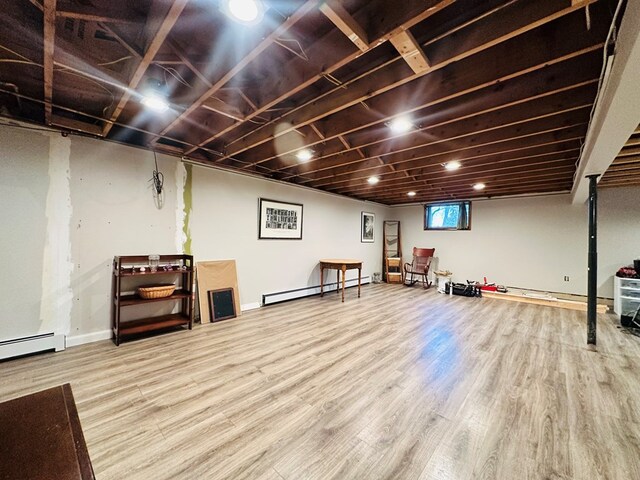 interior space with hardwood / wood-style flooring and a baseboard heating unit