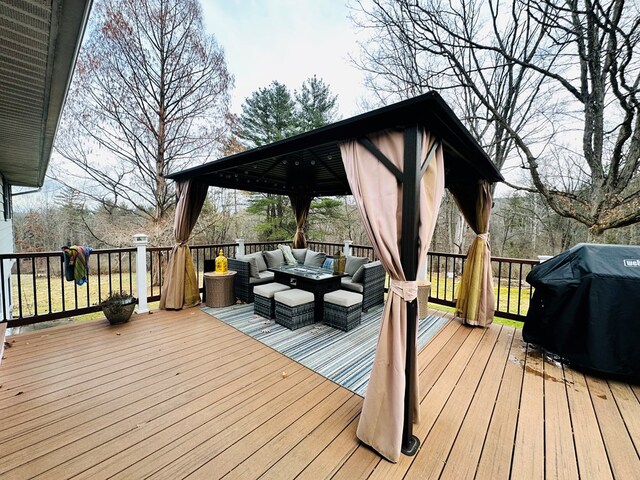 wooden terrace featuring area for grilling and outdoor lounge area