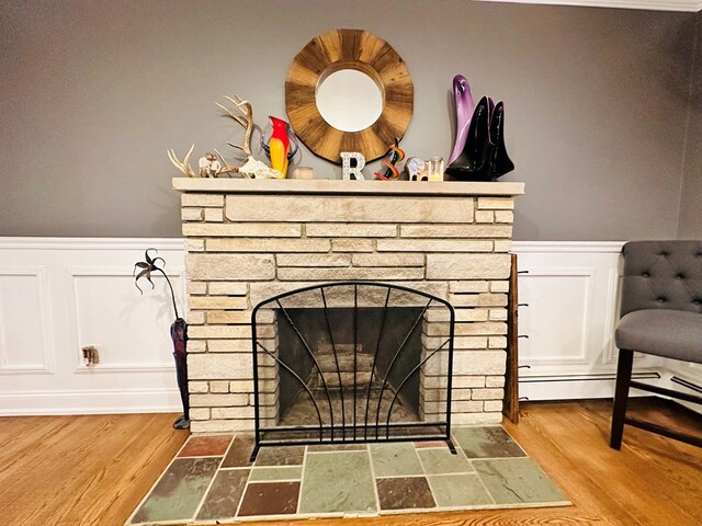 interior details with hardwood / wood-style flooring and a stone fireplace