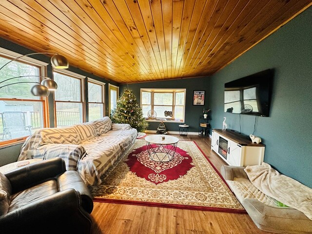 living room featuring lofted ceiling, a wealth of natural light, wood-type flooring, and wooden ceiling