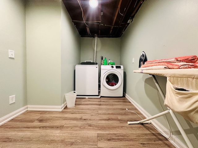 laundry room featuring washer and dryer and light wood-type flooring