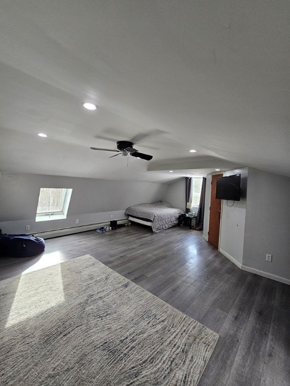 unfurnished bedroom featuring ceiling fan, dark hardwood / wood-style floors, vaulted ceiling, and multiple windows