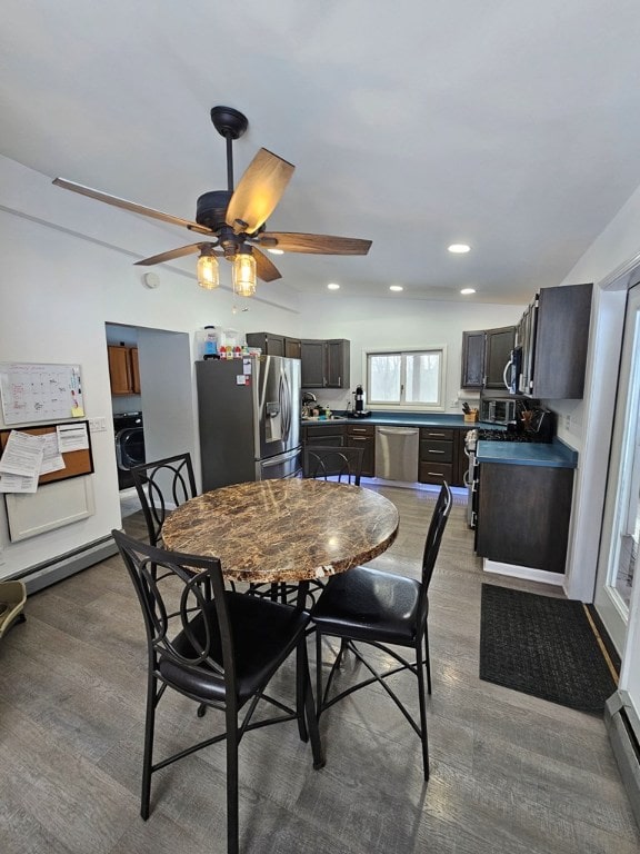 dining area featuring washer / clothes dryer, light hardwood / wood-style flooring, ceiling fan, and baseboard heating