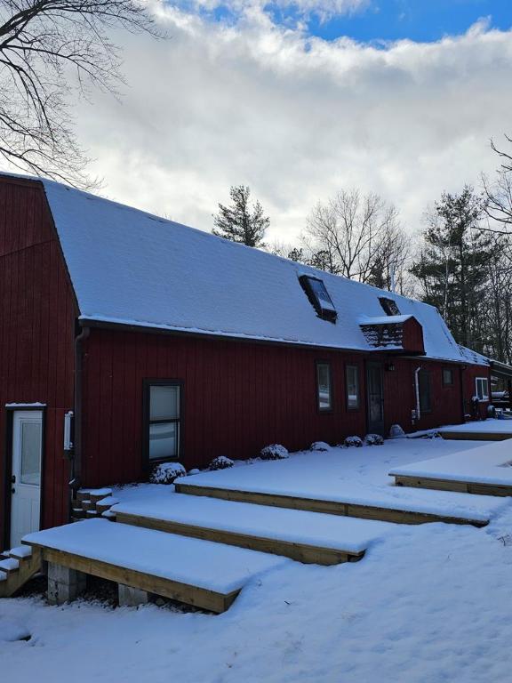 snow covered property with an outdoor structure