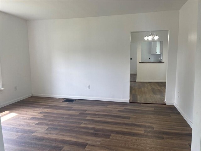 350 E High St, Erwin, NY 14870 - unfurnished room with a chandelier and dark wood-style floors