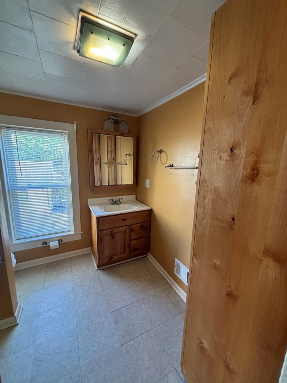 bathroom with vanity and crown molding