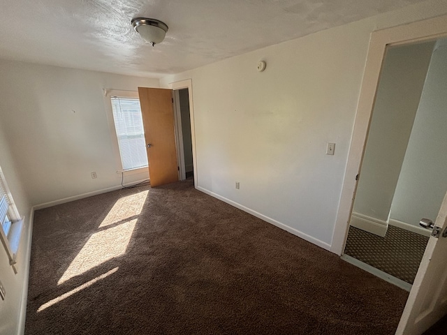 carpeted empty room featuring a textured ceiling