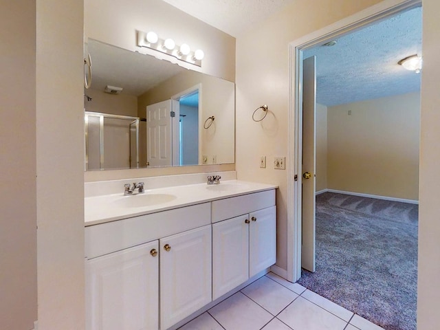 11827 Lando Ln, Corning, NY 14830 - bathroom with double vanity, a textured ceiling, baseboards, and a sink