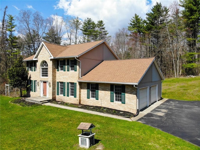 11827 Lando Ln, Corning, NY 14830 - colonial-style house with brick siding, aphalt driveway, roof with shingles, a front lawn, and an attached garage